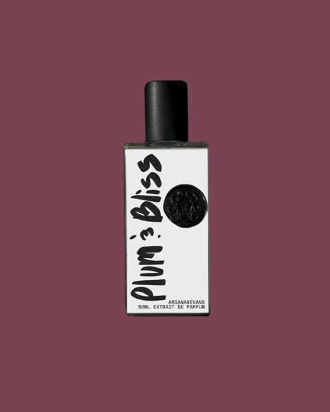 Perfume bottle labeled 'Plum & Bliss' on a solid plum color background. Best Niche Fragrances